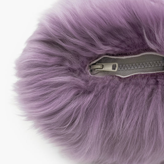 The Mood Charlie Sheepskin Double-sided Pillow in a deep mauve purple color, close-up view of zipper closure
