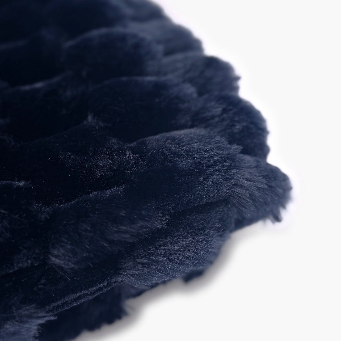 The Mood Honey Faux Fur Throw, 50x60 in., Mid-night Blue; Close-up of a dark navy honeycomb textured faux fur blanket on a white background