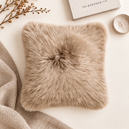 The Mood Charlie Sheepskin 16x16 inch Pillow in sand color, in a warm minimalist studio setting, front view