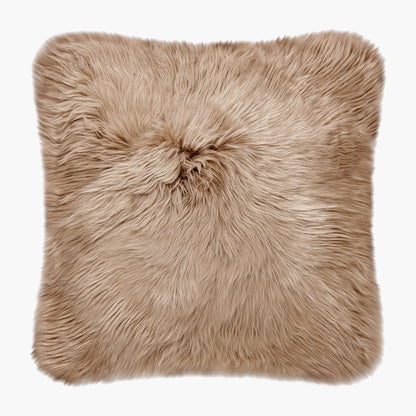 The Mood Charlie Sheepskin Double-sided Square Pillow in a sandy brown color, on a white background, front view