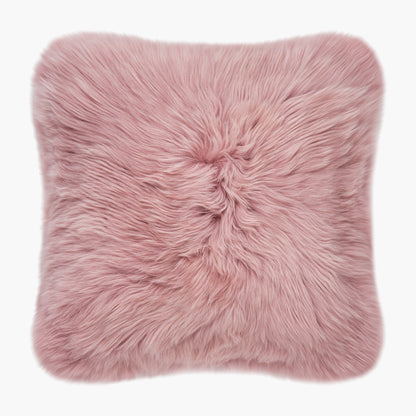 The Mood Charlie Sheepskin Double-sided Square Pillow in a pastel pink color, on a white background, front view