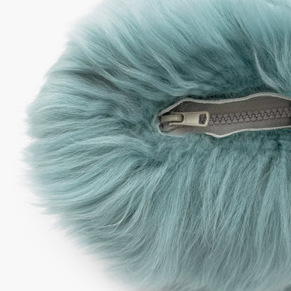 The Mood Charlie Sheepskin Double-sided Pillow in a pastel blue color, close-up view of zipper closure