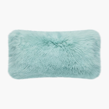The Mood Charlie Sheepskin Double-sided Lumbar Pillow in a pastel blue color, on a white background, front view